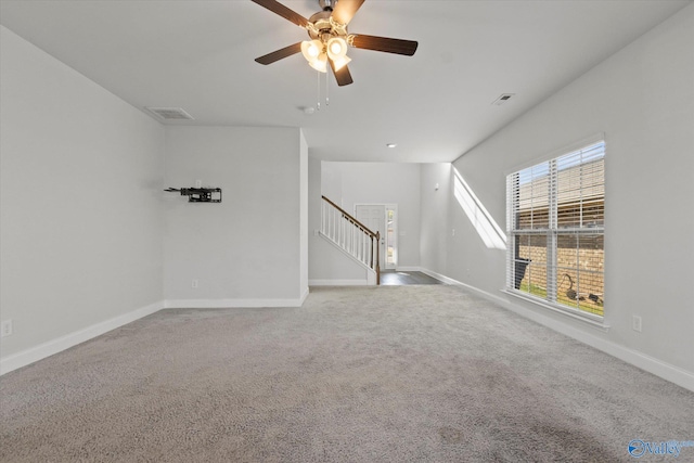 unfurnished living room featuring carpet flooring and ceiling fan