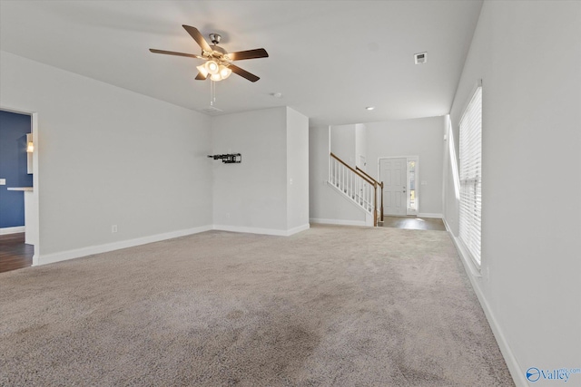 unfurnished living room with ceiling fan and carpet flooring