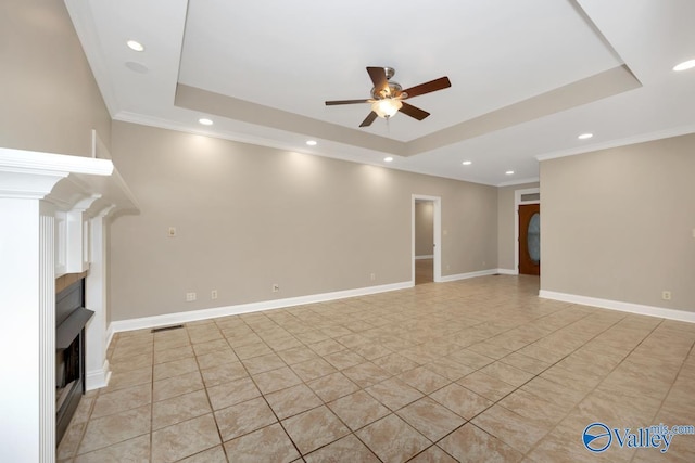 unfurnished living room with recessed lighting, a fireplace, ceiling fan, crown molding, and a tray ceiling