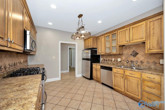 kitchen with a sink, backsplash, appliances with stainless steel finishes, light tile patterned flooring, and recessed lighting