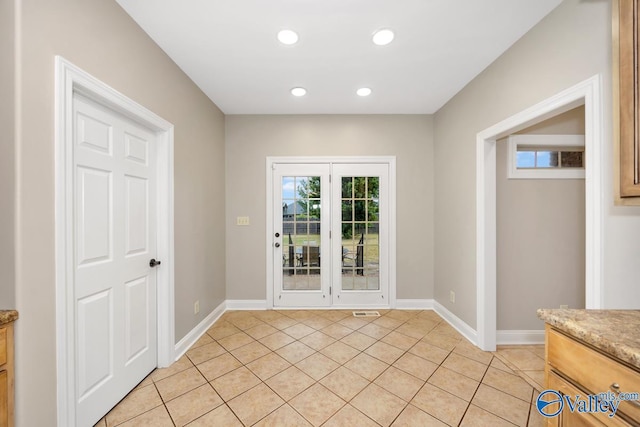doorway to outside featuring visible vents, baseboards, light tile patterned floors, and recessed lighting