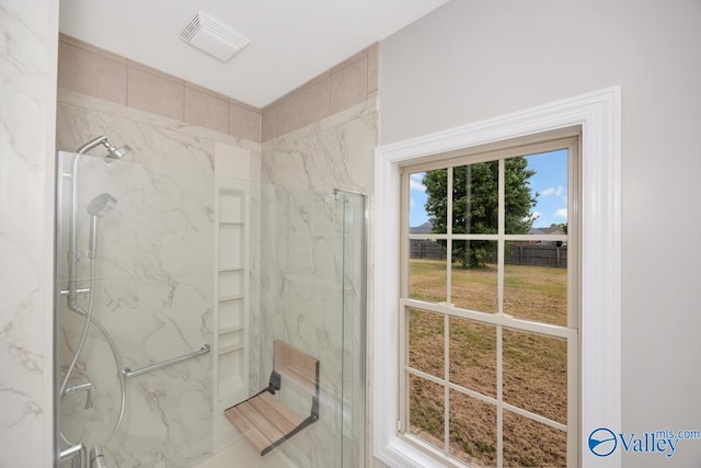 full bathroom with visible vents and a marble finish shower