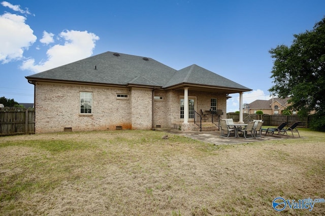 back of house with a yard, fence, a patio, crawl space, and roof with shingles