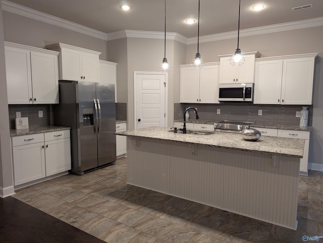 kitchen with stainless steel appliances, pendant lighting, white cabinetry, and sink