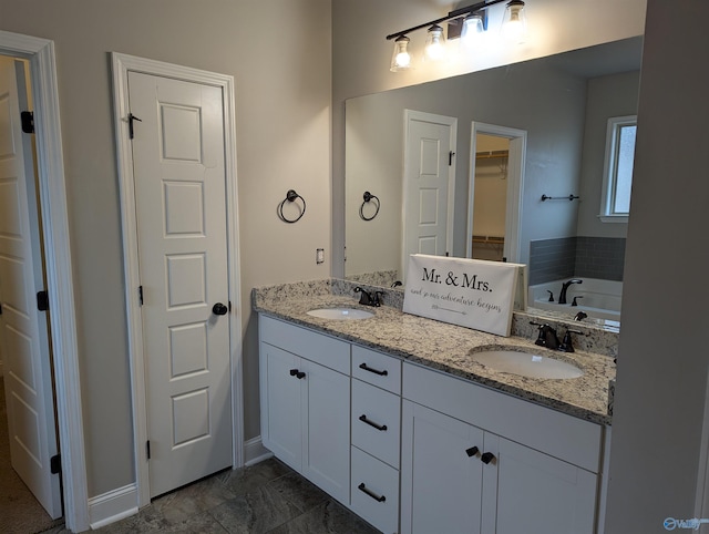 bathroom featuring vanity and a tub