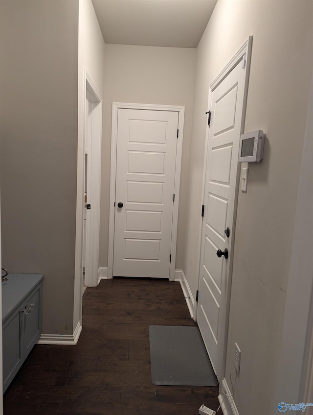 corridor with dark wood-type flooring