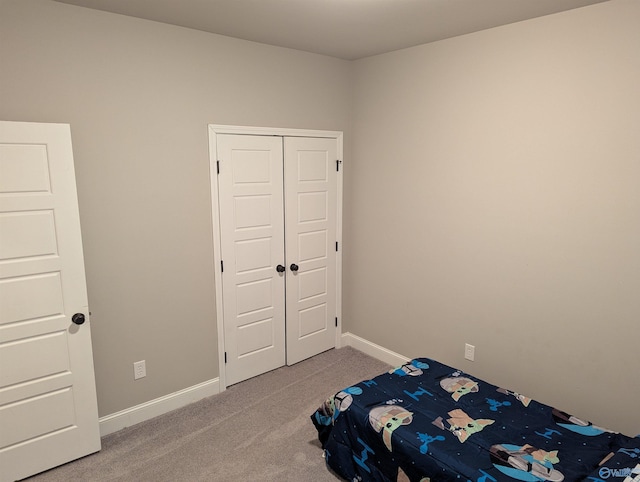 unfurnished bedroom with a closet and carpet flooring