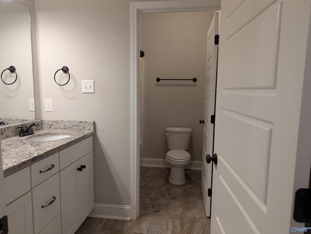 bathroom with toilet and vanity