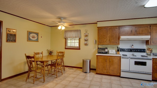 kitchen featuring light countertops, under cabinet range hood, double oven range, and ornamental molding