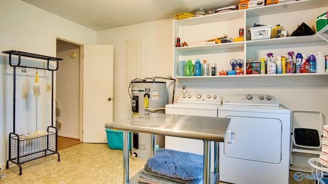 clothes washing area featuring independent washer and dryer, laundry area, and electric water heater