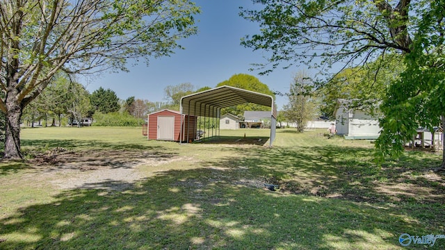view of yard featuring a carport, dirt driveway, a shed, and an outbuilding