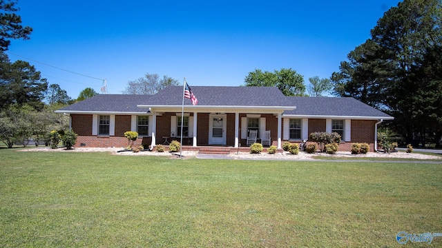 ranch-style house featuring brick siding, a front yard, and covered porch