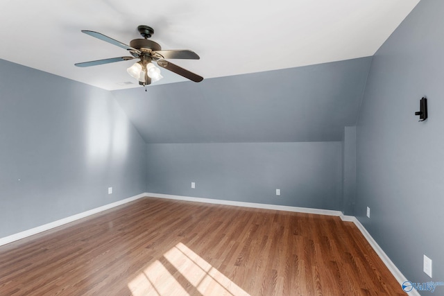 bonus room with baseboards, ceiling fan, vaulted ceiling, and wood finished floors