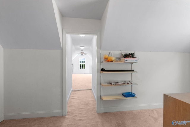 corridor with baseboards and carpet flooring