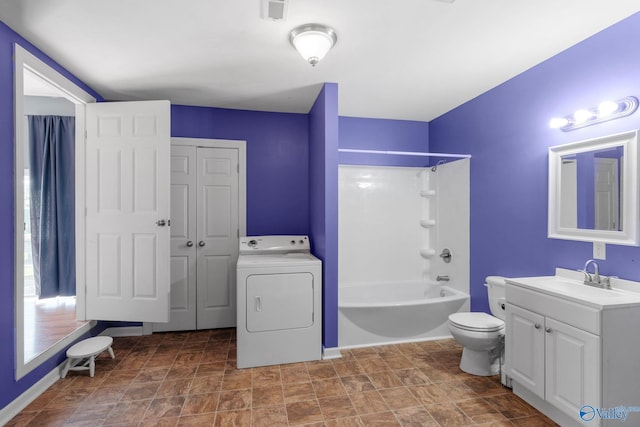 full bathroom with vanity, toilet, washer / clothes dryer, stone finish flooring, and  shower combination