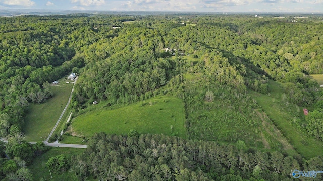 birds eye view of property with a view of trees