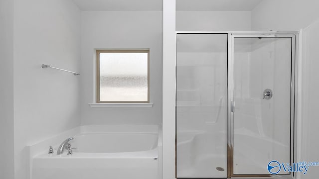 bathroom with separate shower and tub