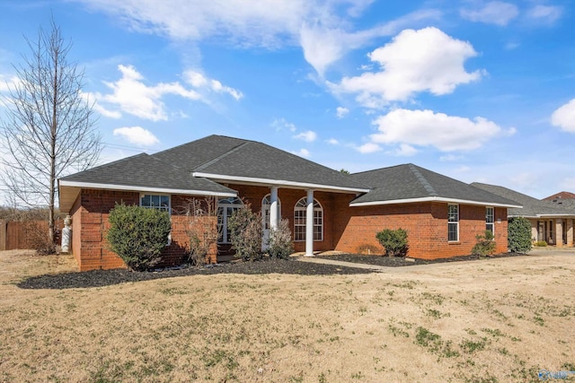 single story home featuring brick siding and a shingled roof