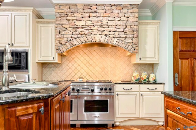 kitchen featuring dark stone counters, decorative backsplash, double oven range, and crown molding