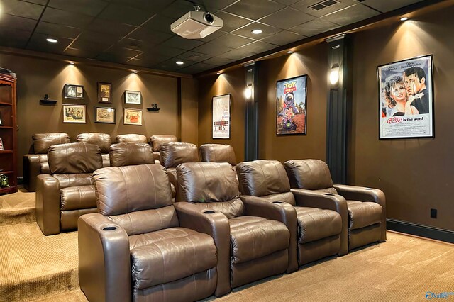 carpeted cinema featuring a drop ceiling