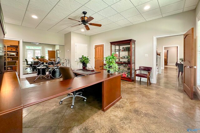 tiled office space featuring ceiling fan