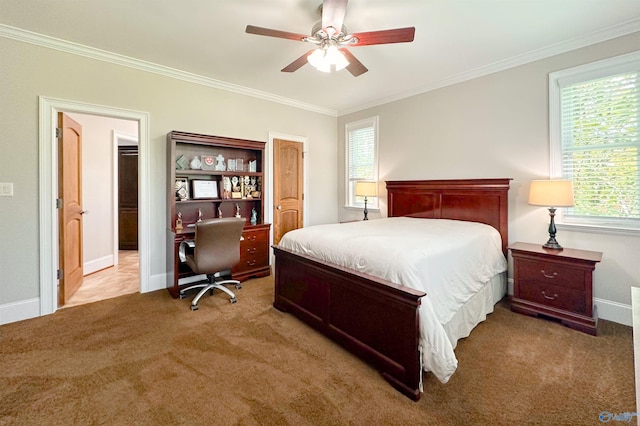 carpeted bedroom with a ceiling fan, baseboards, and ornamental molding