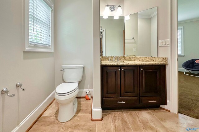 bathroom featuring tile patterned flooring, crown molding, toilet, and vanity