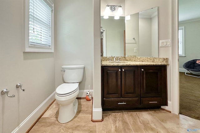 bathroom featuring vanity, toilet, baseboards, and ornamental molding