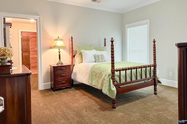 carpeted bedroom featuring baseboards, crown molding, and visible vents