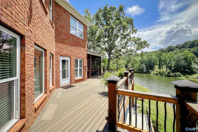 wooden terrace featuring a water view