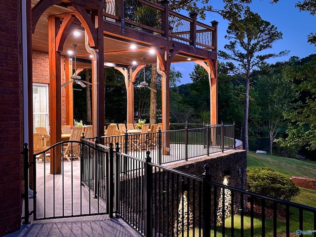 view of patio with a wooden deck and fence