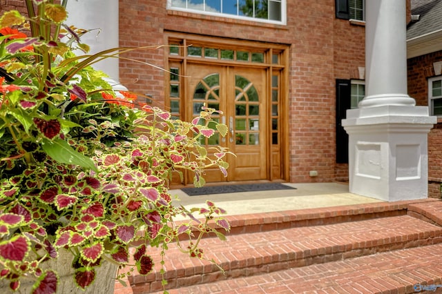 property entrance featuring brick siding