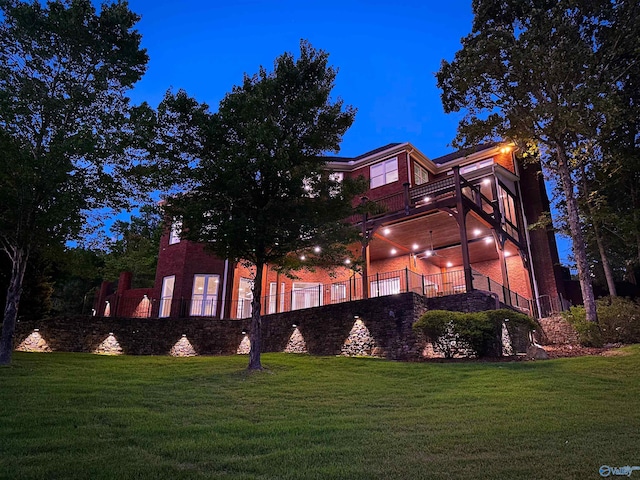 exterior space featuring a lawn and a balcony