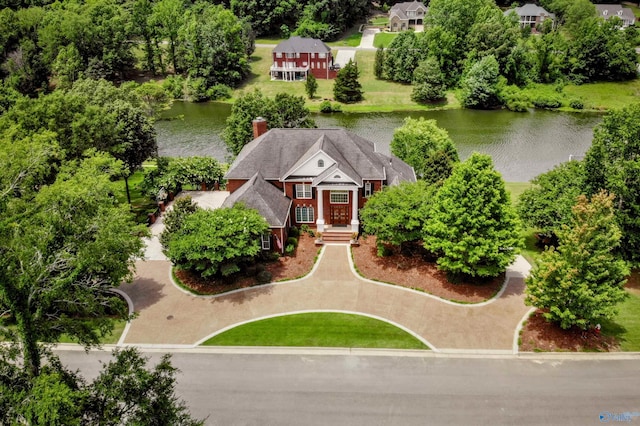view of front of property featuring a chimney and a water view