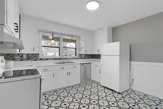 kitchen with dishwasher, sink, stove, white fridge, and white cabinets