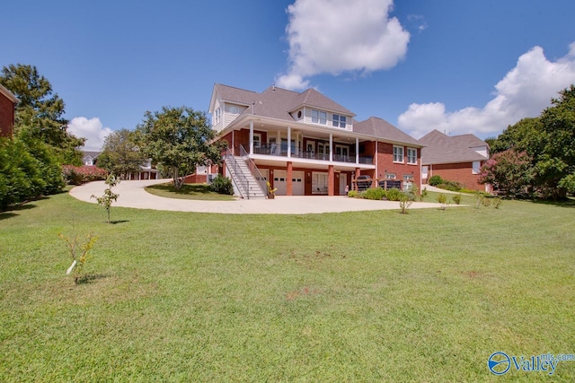 rear view of property with a yard and a garage