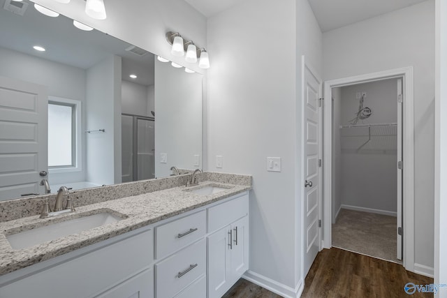 bathroom with separate shower and tub, hardwood / wood-style flooring, and double sink vanity