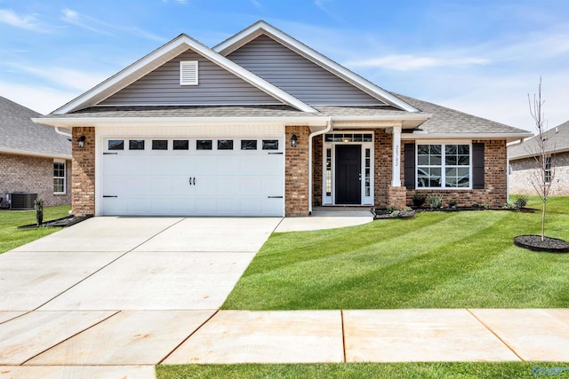 view of front of house featuring an attached garage, central AC, brick siding, concrete driveway, and a front yard