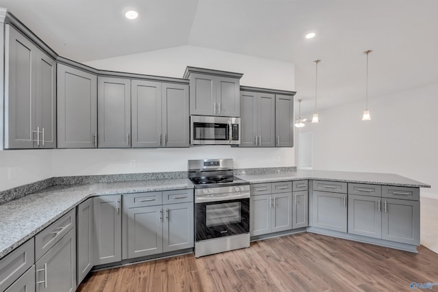 kitchen featuring stainless steel appliances, gray cabinets, hanging light fixtures, and light stone counters