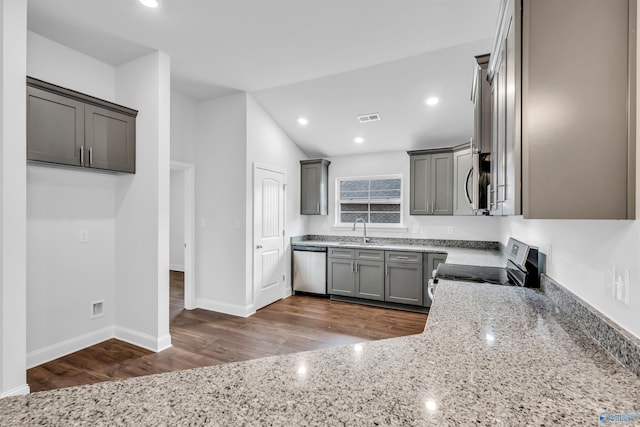 kitchen with light stone counters, stainless steel appliances, a sink, visible vents, and gray cabinets