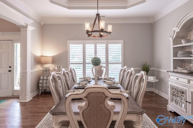 dining room featuring crown molding, decorative columns, plenty of natural light, and dark hardwood / wood-style flooring