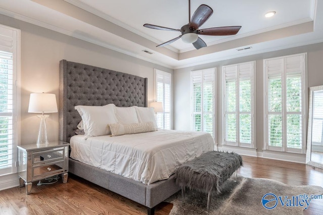 bedroom with crown molding, hardwood / wood-style floors, and ceiling fan