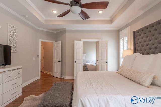 bedroom with ceiling fan, a tray ceiling, crown molding, and hardwood / wood-style floors