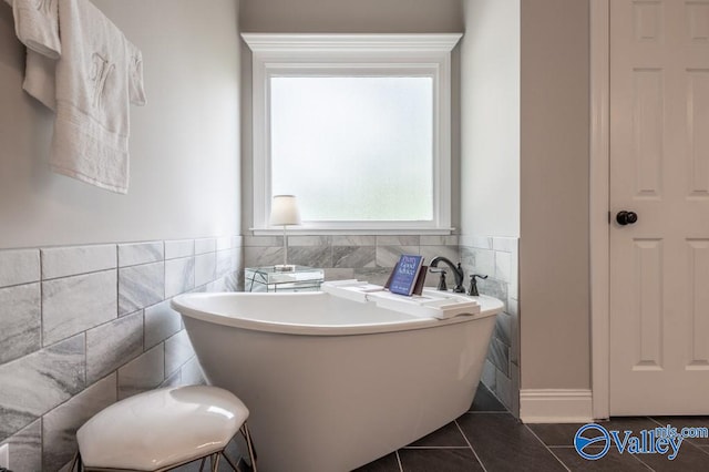 bathroom with tile walls, tile patterned floors, and a tub