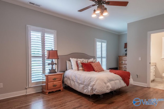 bedroom with ornamental molding, ensuite bath, ceiling fan, and hardwood / wood-style flooring