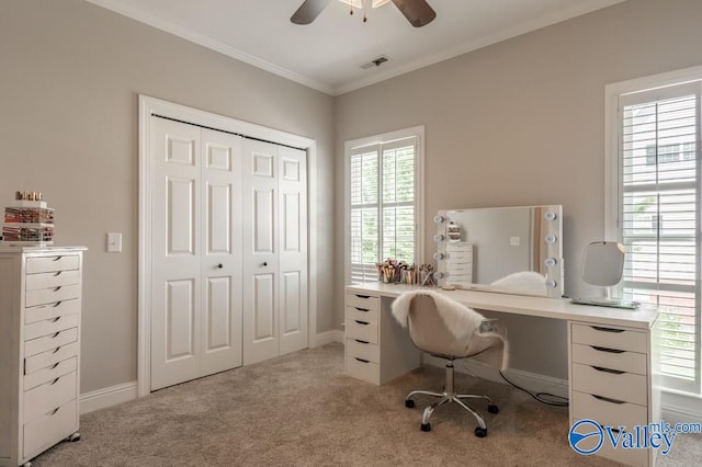 office space featuring ceiling fan, light colored carpet, plenty of natural light, and crown molding