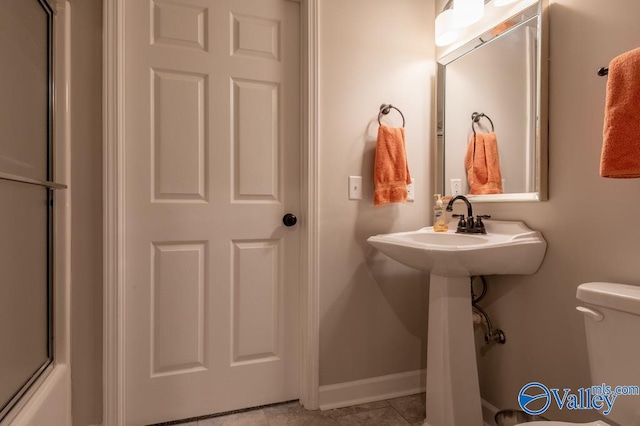 bathroom featuring toilet and tile patterned floors