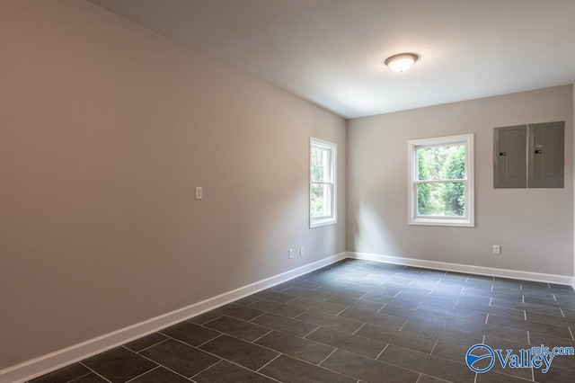 unfurnished room featuring electric panel