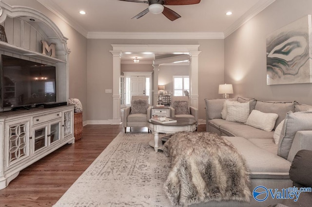 living room featuring crown molding, decorative columns, dark hardwood / wood-style floors, and ceiling fan