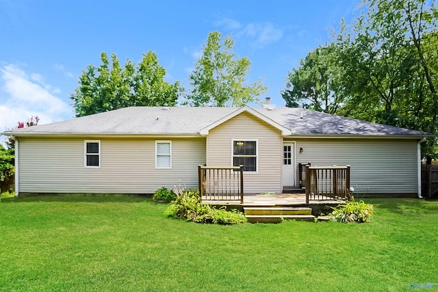 rear view of house featuring a lawn and a wooden deck